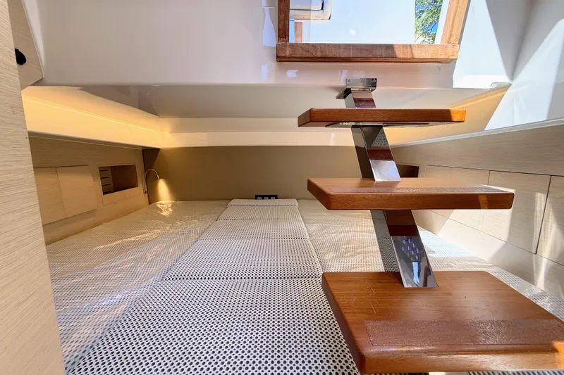 Mine Yacht Photos Pics Interior of 2022 Tesoro T38 Outboard, featuring modern wooden steps and cozy cabin space.