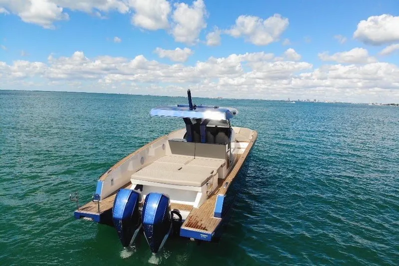 Mine Yacht Photos Pics 2022 Tesoro T38 Outboard boat on open water under a blue sky.