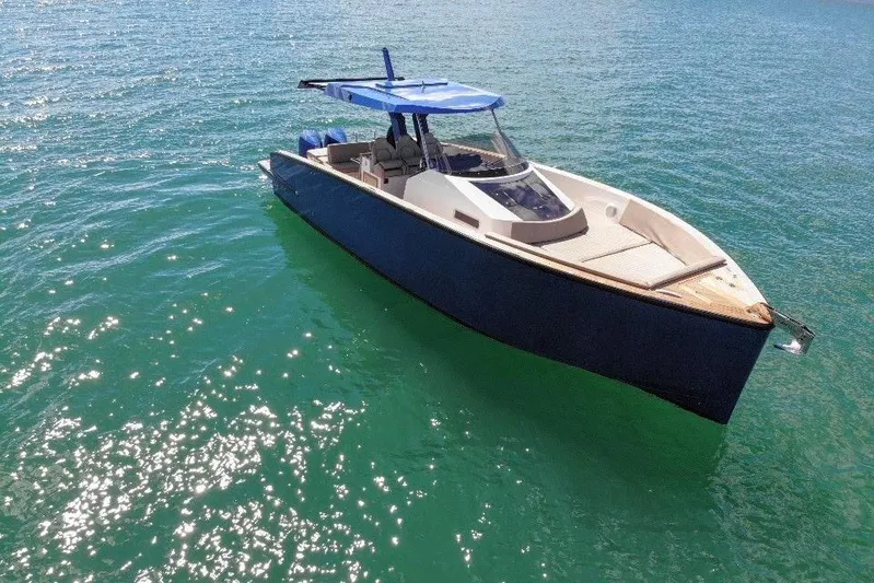 Mine Yacht Photos Pics 2022 Tesoro T38 Outboard boat on clear blue water, featuring sleek design and modern amenities.