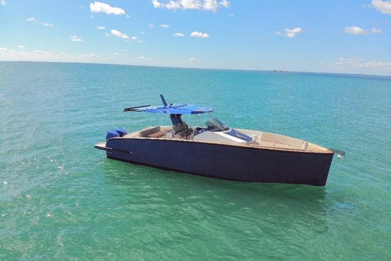 Mine Yacht Photos Pics 2022 Tesoro T38 Outboard boat on calm blue sea under clear sky.