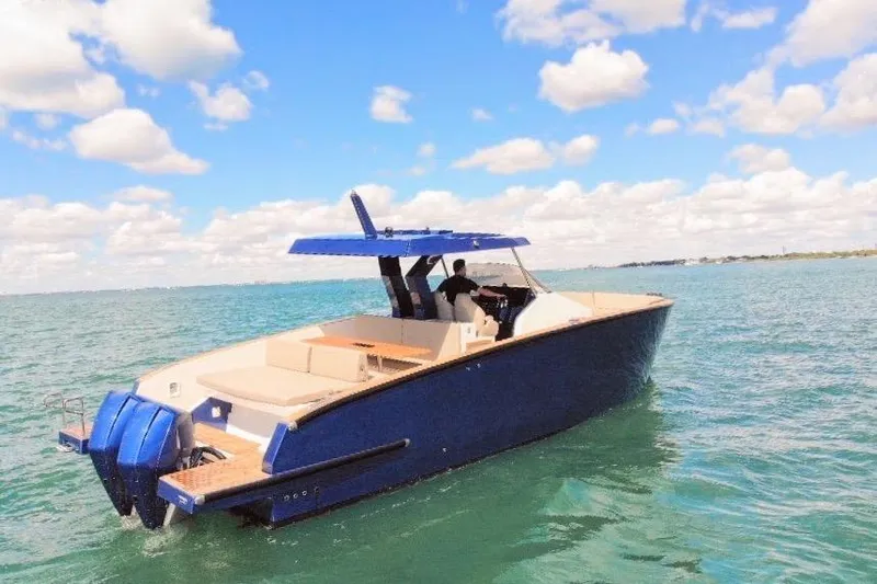 Mine Yacht Photos Pics 2022 Tesoro T38 Outboard boat cruising on a sunny day with clear skies.