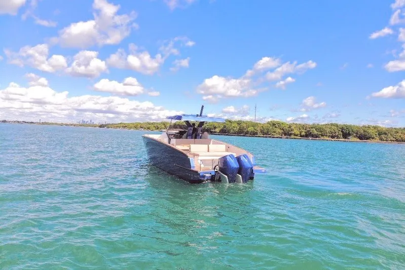 Mine Yacht Photos Pics 2022 Tesoro T38 Outboard boat on clear blue water under a sunny sky.