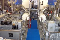 Engine room of 2009 Tecnomar 100 yacht, featuring dual engines and metallic piping.