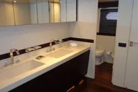 Luxury bathroom in 2009 Tecnomar 100 yacht with dual sinks and modern fixtures.