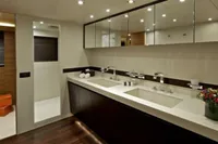Luxurious Tecnomar 100 yacht bathroom with dual sinks, modern fixtures, and elegant lighting, 2009 model.