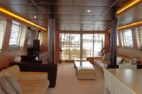 Luxurious interior of 2009 Tecnomar 100 yacht with modern furnishings and ambient lighting.