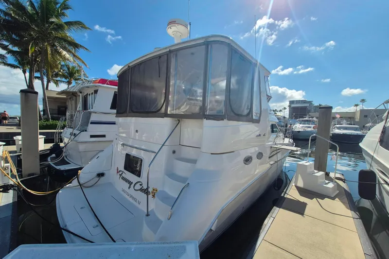 Funny Cide Yacht Photos Pics 1999 Sea Ray 420 Aft Cabin yacht docked at marina under clear blue sky.