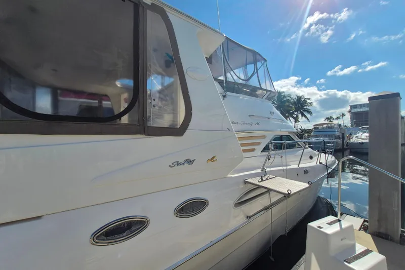 Funny Cide Yacht Photos Pics 1999 Sea Ray 420 Aft Cabin yacht docked under a sunny sky.