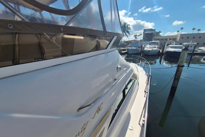 Funny Cide Yacht Photos Pics 1999 Sea Ray 420 Aft Cabin yacht docked at marina under clear blue sky.