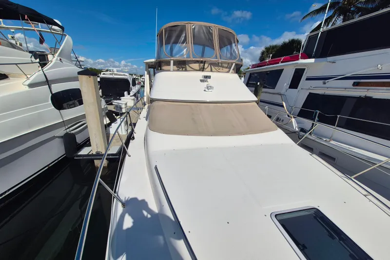 Funny Cide Yacht Photos Pics 1999 Sea Ray 420 Aft Cabin yacht docked at marina under clear blue sky.