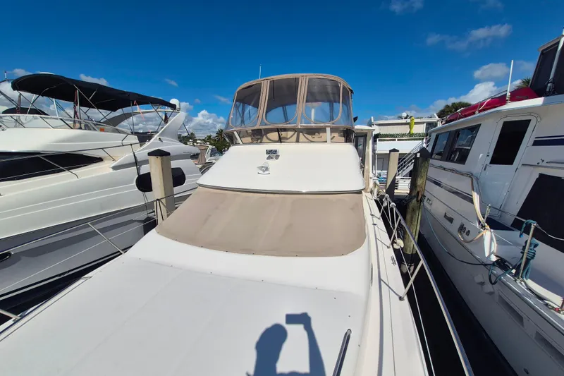 Funny Cide Yacht Photos Pics 1999 Sea Ray 420 Aft Cabin yacht docked under clear blue sky.