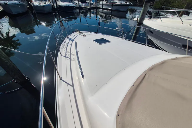 Funny Cide Yacht Photos Pics 1999 Sea Ray 420 Aft Cabin yacht docked at marina, sunny day reflection on water.