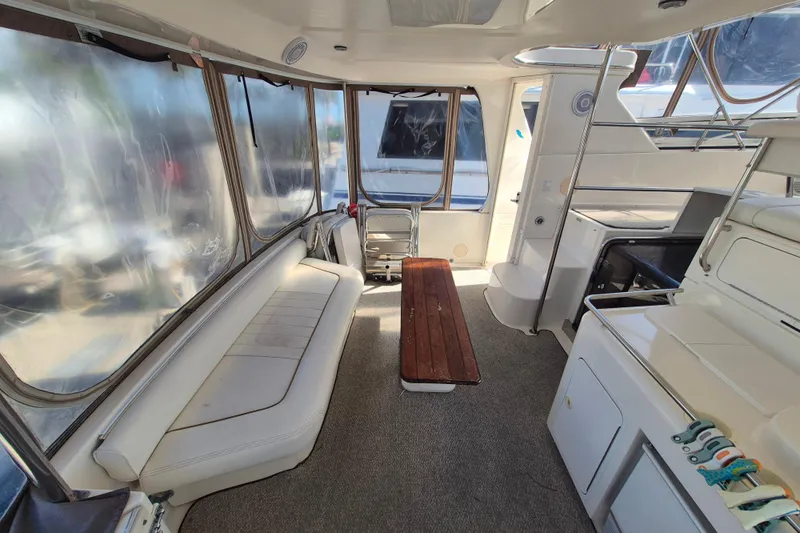 Funny Cide Yacht Photos Pics 1999 Sea Ray 420 Aft Cabin interior with seating, table, and windows.