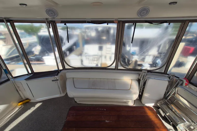 Funny Cide Yacht Photos Pics 1999 Sea Ray 420 Aft Cabin interior with seating and large windows.