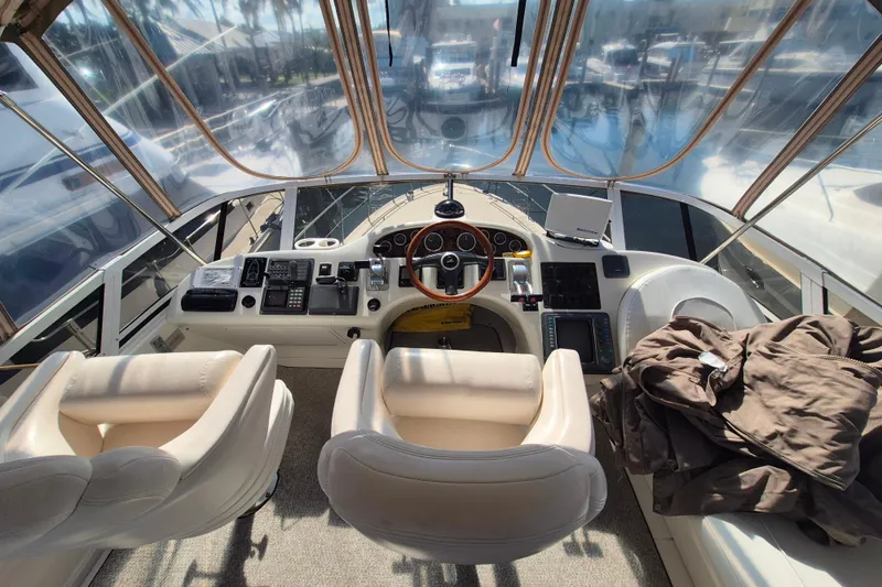 Funny Cide Yacht Photos Pics Interior view of 1999 Sea Ray 420 Aft Cabin yacht cockpit with steering wheel and controls.