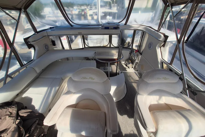 Funny Cide Yacht Photos Pics 1999 Sea Ray 420 Aft Cabin interior with plush seating and panoramic windows.