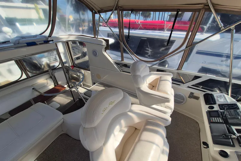 Funny Cide Yacht Photos Pics 1999 Sea Ray 420 Aft Cabin interior with plush seating and helm controls.