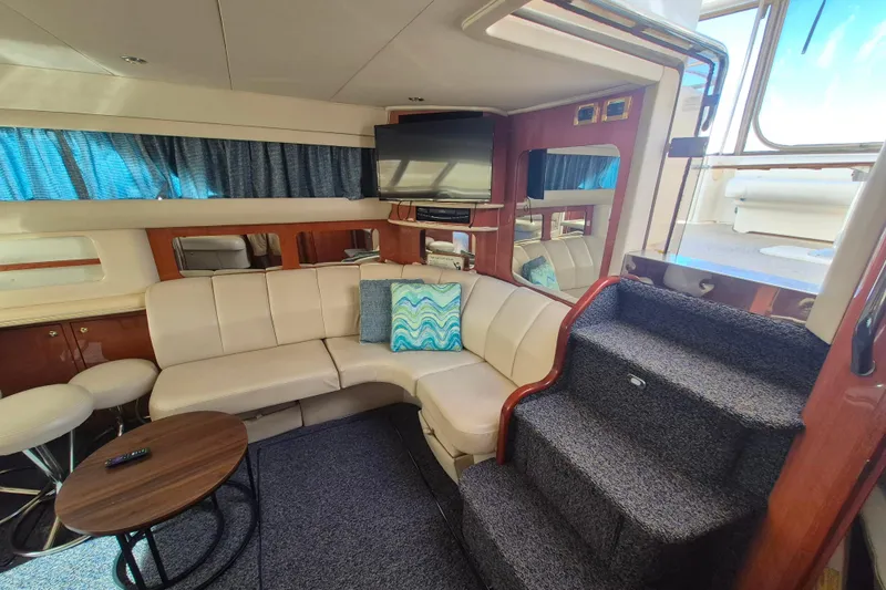 Funny Cide Yacht Photos Pics Luxurious interior of 1999 Sea Ray 420 Aft Cabin yacht with plush seating and modern amenities.