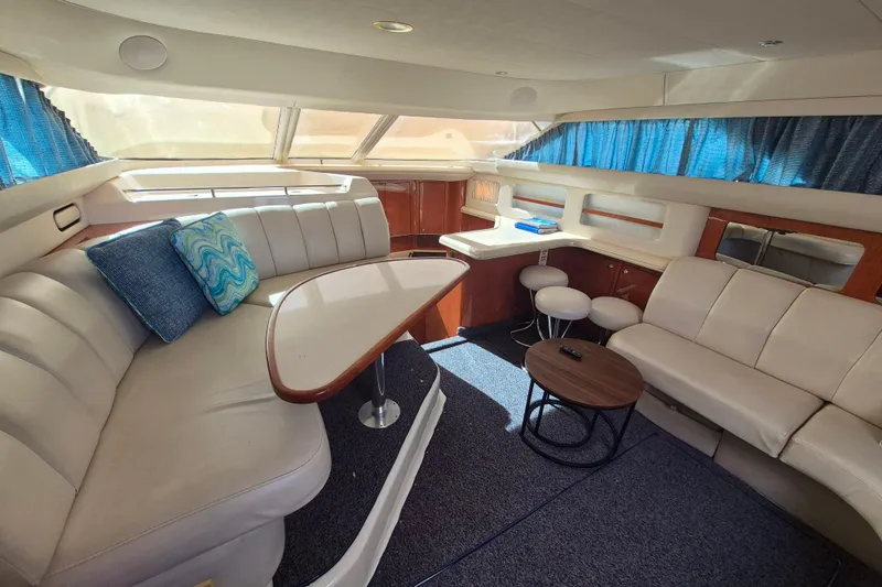 Funny Cide Yacht Photos Pics Luxurious interior of 1999 Sea Ray 420 Aft Cabin yacht with plush seating and elegant decor.