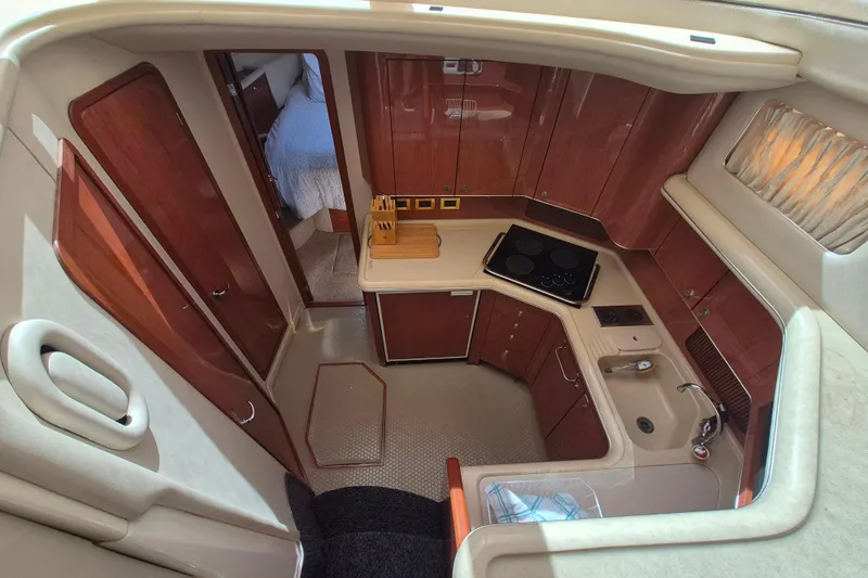 Funny Cide Yacht Photos Pics 1999 Sea Ray 420 Aft Cabin yacht interior with kitchen and wood cabinetry.