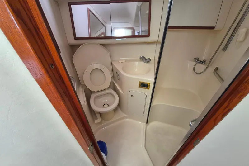Funny Cide Yacht Photos Pics 1999 Sea Ray 420 Aft Cabin bathroom with toilet, sink, and shower.