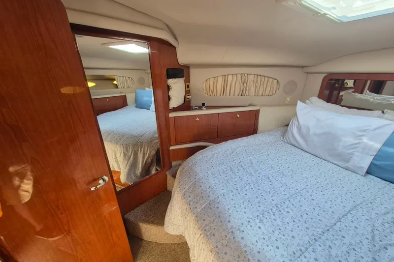 Funny Cide Yacht Photos Pics 1999 Sea Ray 420 Aft Cabin interior with cozy bedroom and elegant wood finishes.