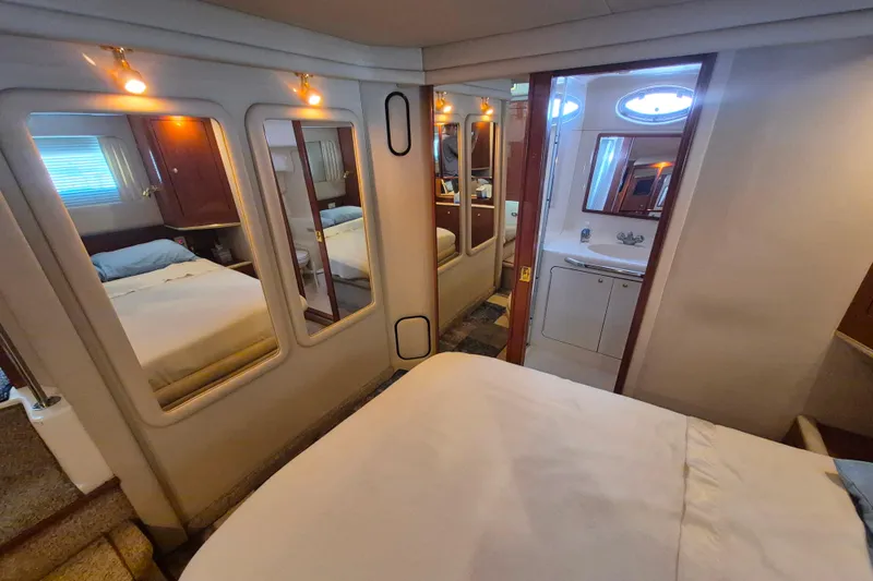 Funny Cide Yacht Photos Pics 1999 Sea Ray 420 Aft Cabin interior with mirrors, bed, and bathroom view.
