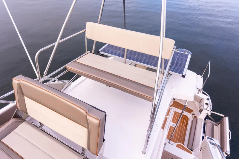  Yacht Photos Pics 2021 Cutwater C-32 CB boat deck with seating and railing, overlooking calm water.