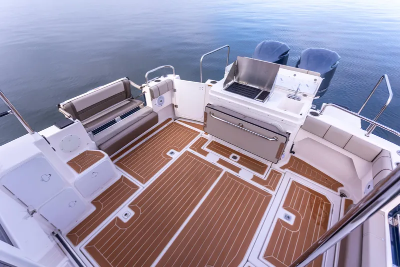  Yacht Photos Pics 2021 Cutwater C-32 CB boat deck with seating and grill, overlooking calm water.