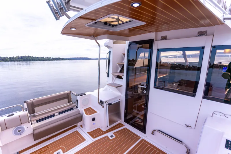  Yacht Photos Pics 2021 Cutwater C-32 CB boat interior with wood accents and lake view.