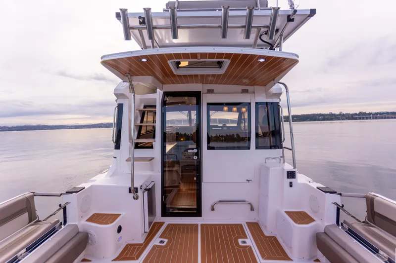  Yacht Photos Pics 2021 Cutwater C-32 CB boat, rear view, spacious deck, modern design, calm water backdrop.