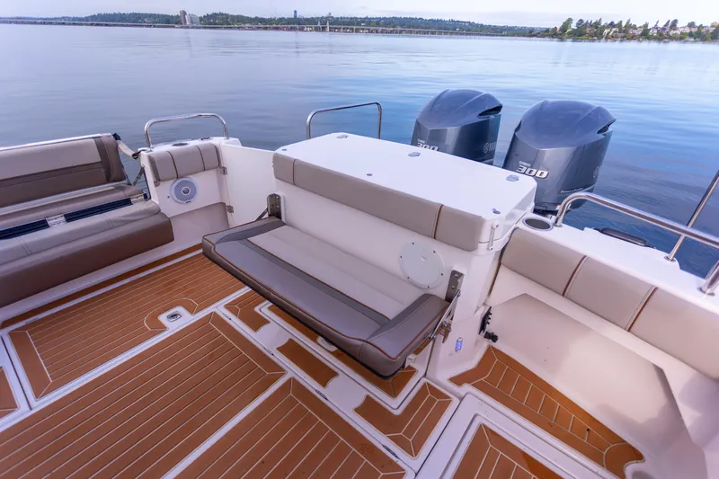  Yacht Photos Pics 2021 Cutwater C-32 CB boat deck with seating and twin outboard engines on calm water.