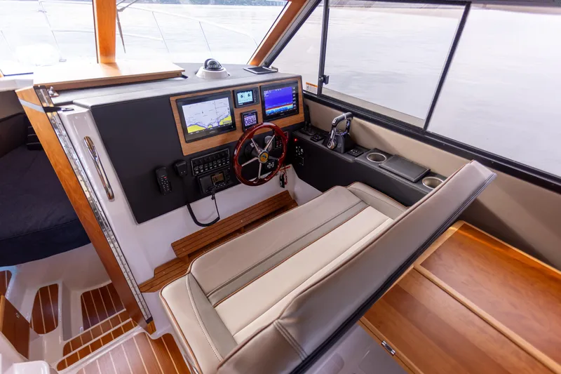 Yacht Photos Pics 2021 Cutwater C-32 CB helm with navigation screens and comfortable seating.