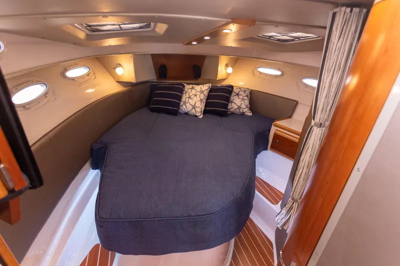  Yacht Photos Pics 2021 Cutwater C-32 CB cabin interior with cozy bed and ambient lighting.