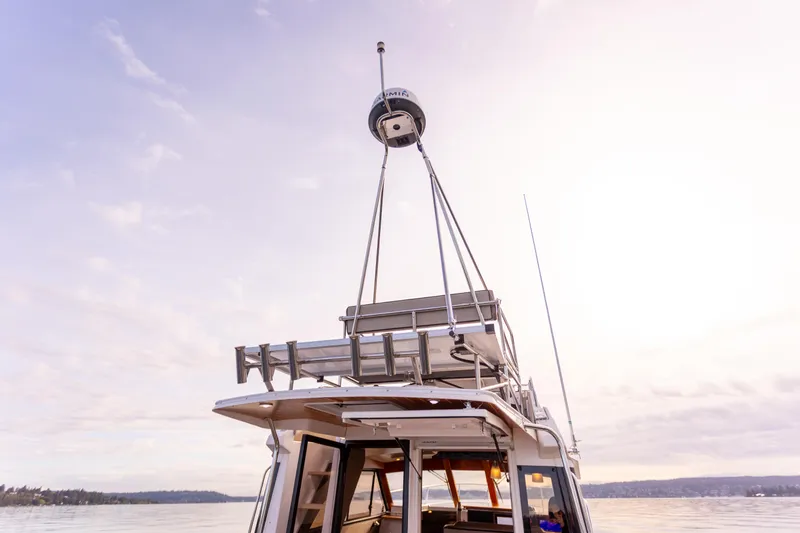  Yacht Photos Pics 2021 Cutwater C-32 CB boat on calm water under a pastel sky.