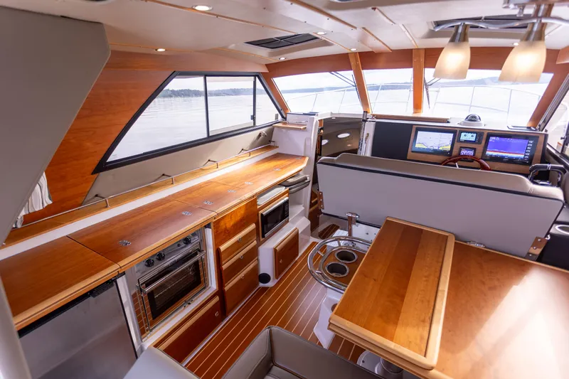  Yacht Photos Pics Interior of 2021 Cutwater C-32 CB yacht with modern kitchen and navigation area.