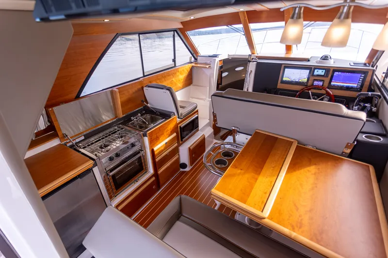  Yacht Photos Pics Interior of 2021 Cutwater C-32 CB boat with modern kitchen and seating area.