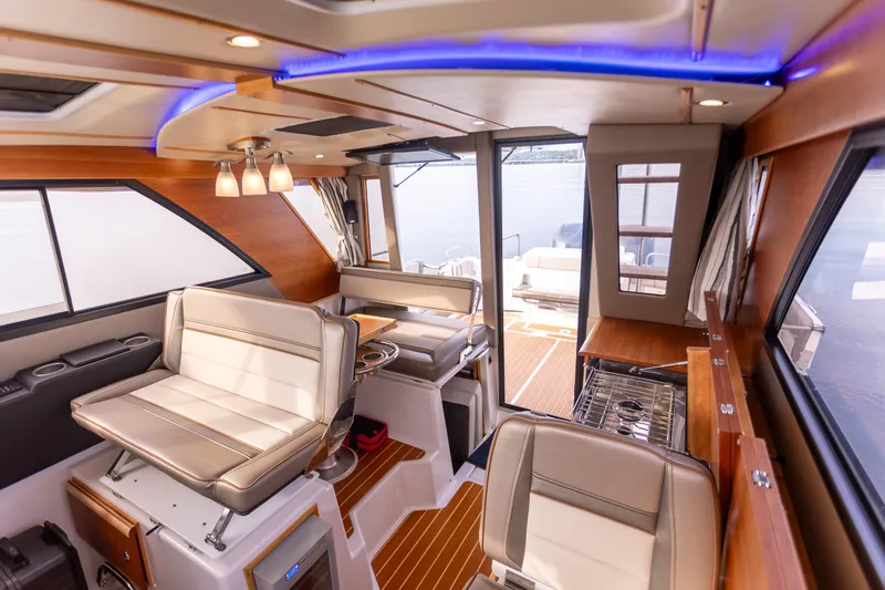  Yacht Photos Pics Interior of 2021 Cutwater C-32 CB boat, featuring modern seating and wood accents.