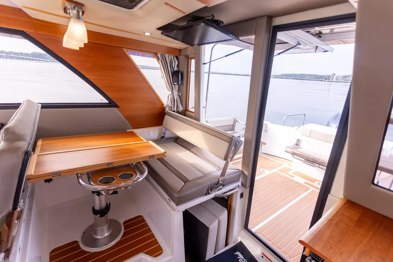  Yacht Photos Pics Interior of 2021 Cutwater C-32 CB boat with seating and table, overlooking water.