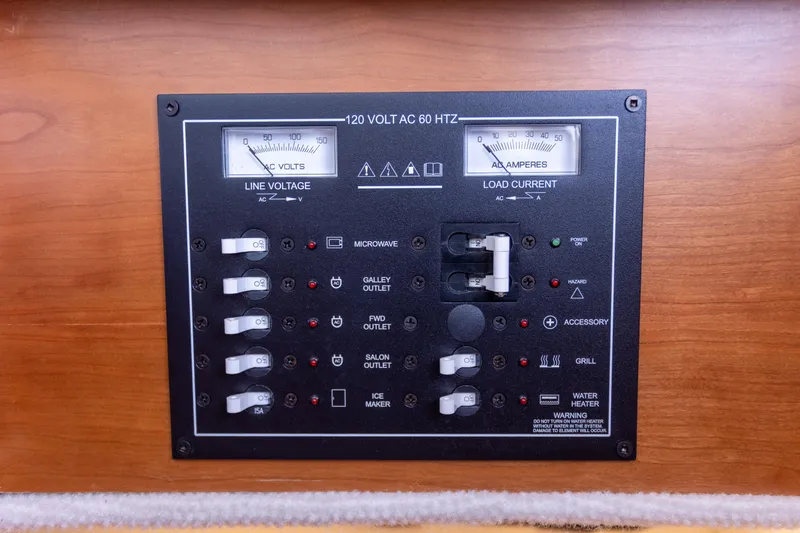 Yacht Photos Pics Electrical panel on a 2021 Cutwater C-32 CB boat, showing line voltage and load current.