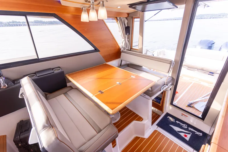  Yacht Photos Pics Interior of 2021 Cutwater C-32 CB boat with elegant dining area and panoramic windows.