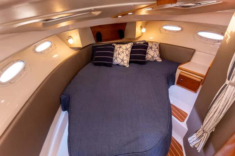  Yacht Photos Pics 2021 Cutwater C-32 CB cabin interior with cozy bed and ambient lighting.