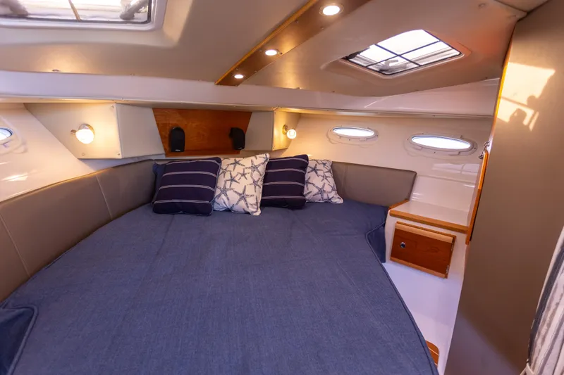  Yacht Photos Pics 2021 Cutwater C-32 CB cabin interior with cozy bed and ambient lighting.