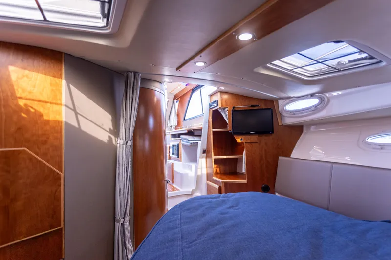  Yacht Photos Pics Interior of 2021 Cutwater C-32 CB boat, featuring wood paneling and a cozy cabin space.