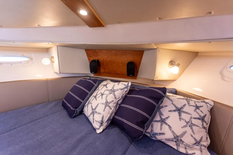  Yacht Photos Pics Cozy cabin interior of 2021 Cutwater C-32 CB with nautical-themed pillows.