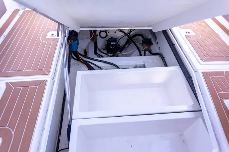  Yacht Photos Pics 2021 Cutwater C-32 CB boat storage compartment with open hatches and visible wiring.