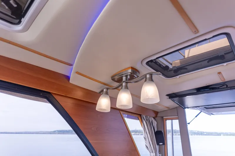  Yacht Photos Pics Interior view of 2021 Cutwater C-32 CB boat with modern ceiling lights.
