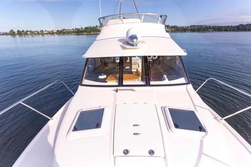  Yacht Photos Pics 2021 Cutwater C-32 CB yacht on calm water, showcasing sleek design and spacious deck.