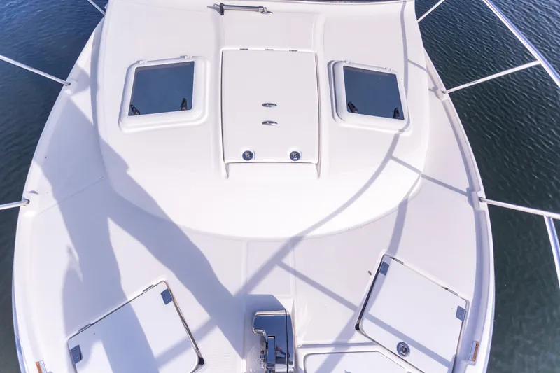  Yacht Photos Pics 2021 Cutwater C-32 CB boat deck with hatches and railing, viewed from above.