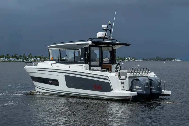  Yacht Photos Pics 2021 Jeanneau NC Sport 895 boat with Yamaha engines on a calm waterway.